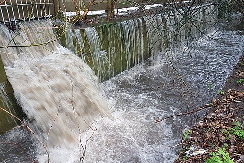 Sewage being discharged into a river.